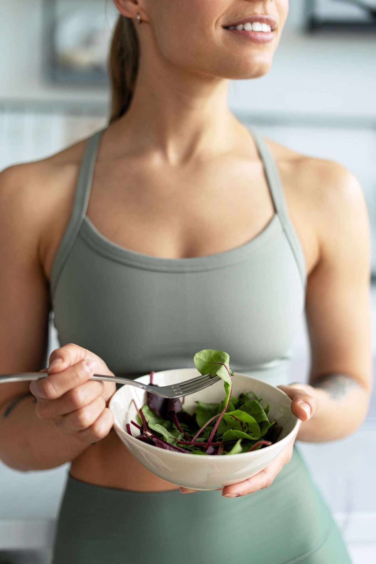 Woman holding a bowl of salad